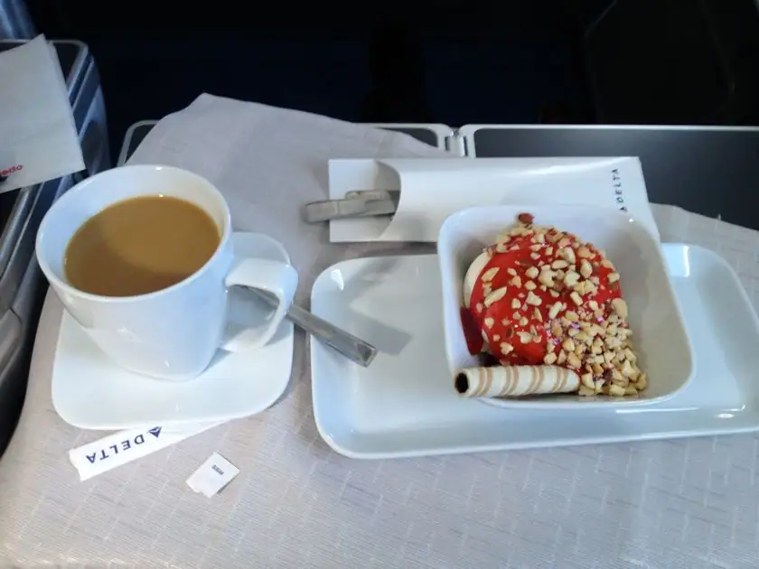 Dessert mit Beeren und Nüssen, dazu Kaffee, in der Delta Business Class